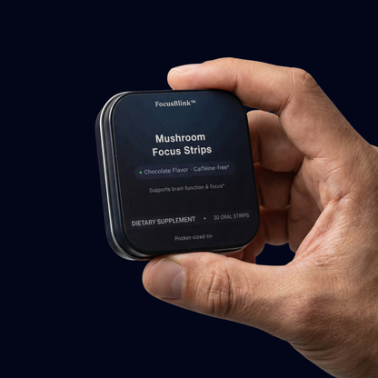 Hand holding a package of FocusBlink Mushroom Focus Strips against a dark background