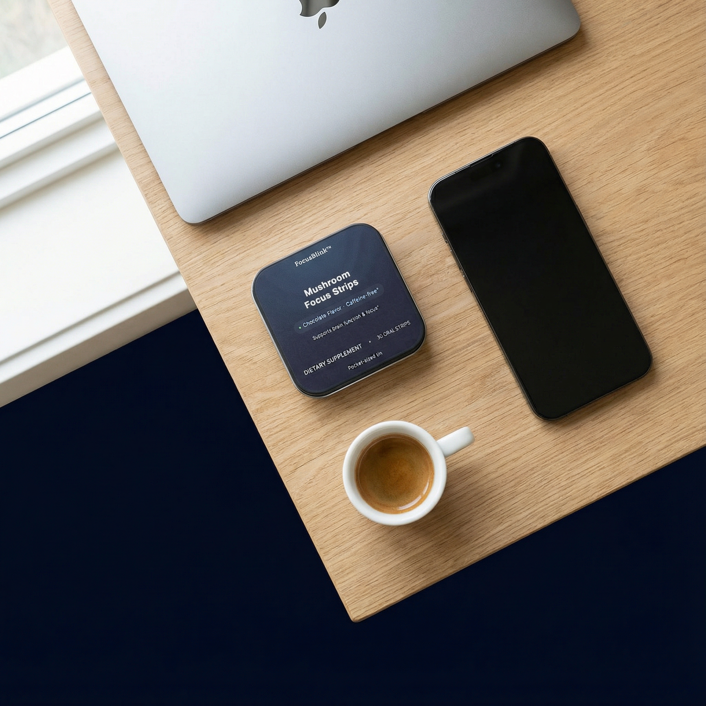 Desk setup with a smartphone, coffee cup, and product packaging on a wooden surface.